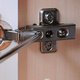 Fixing a cabinet hinge with a screwdriver