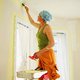 Woman painting wall in preparation for selling her home